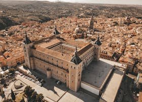 Stunning aerial view of Alcázar of Toledo, showcasing historic architecture and cityscape in Spain.