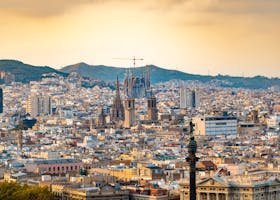 A breathtaking aerial view of Barcelona featuring the iconic Sagrada Familia at sunset.