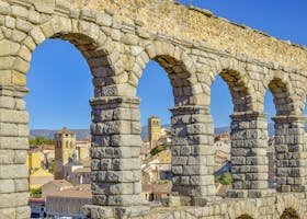 Iconic Roman aqueduct in Segovia with arches overlooking the cityscape.