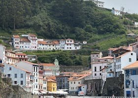 Picturesque view of Cudillero, Spain with colorful buildings by the sea, ideal for travel and lifestyle imagery.
