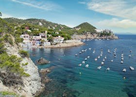 A beautiful view of Tossa de Mar's coastline with vibrant sea and architecture.